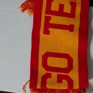 Red/Orange Scarf says GO TEAM GO on one side with fringe on both ends, pockets